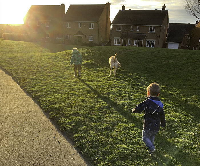 Photograph of my two boys and Mickey running across a field at sunset